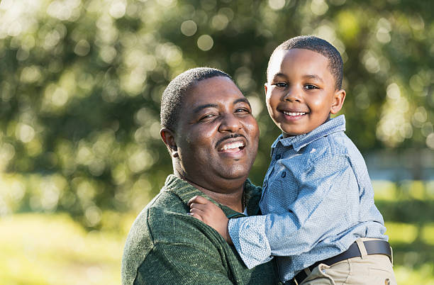 istock African American father holding son in his arms 526298046