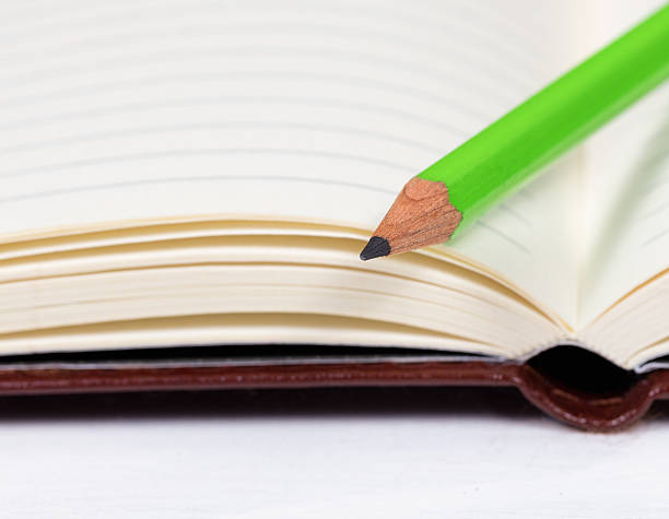 istock Close up of a new sharpen pencil on clean notepad 526298256
