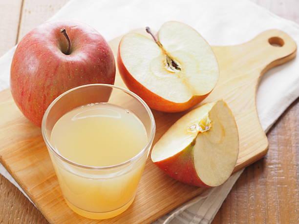 Glass of apple juice and fresh red apple Glass of apple juice and fresh red apple apple juice photos stock pictures, royalty-free photos & images