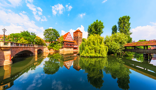 Scenic summer view of the German traditional medieval half-timbered Old Town architecture and bridge over Pegnitz river in Nuremberg, Germany