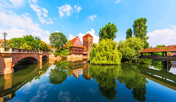 Old Town in Nuremberg, Germany Scenic summer view of the German traditional medieval half-timbered Old Town architecture and bridge over Pegnitz river in Nuremberg, Germany franconia photos stock pictures, royalty-free photos & images