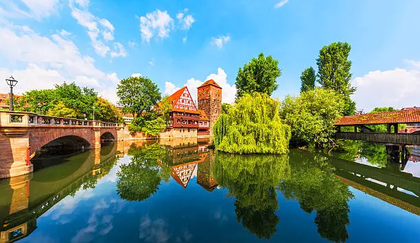 Scenic summer view of the German traditional medieval half-timbered Old Town architecture and bridge over Pegnitz river in Nuremberg, Germany