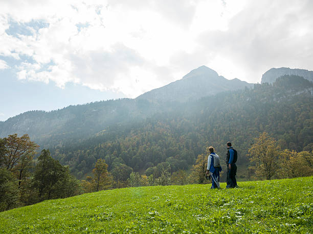 istock Wing suit fliers spread wings in meadow before jump 526306055