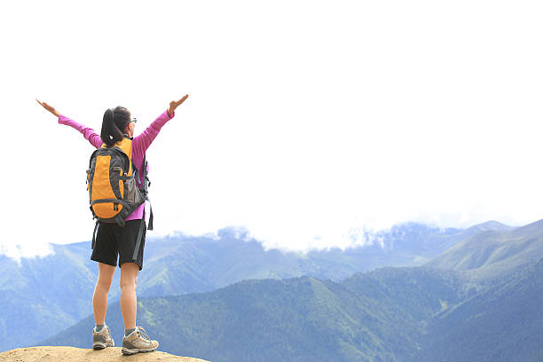 istock cheering hiking woman  mountain peak 526306159