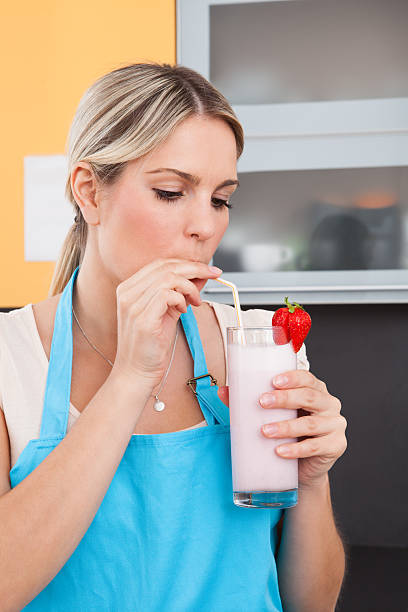 istock Young Woman Drinking Strawberry Milkshake 526306615