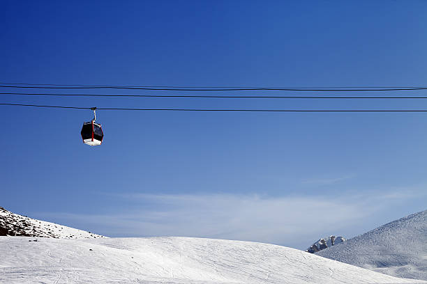istock Gondola lift and ski slope at sun day 526306853
