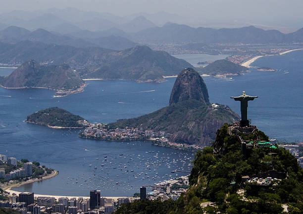 Open arms on guanabar II Christ the Redeemer with background to guanabara bay cristo redentor rio de janeiro stock pictures, royalty-free photos & images