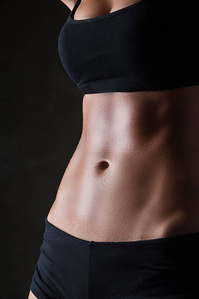 istock Slim woman's body  over dark gray background 526309291