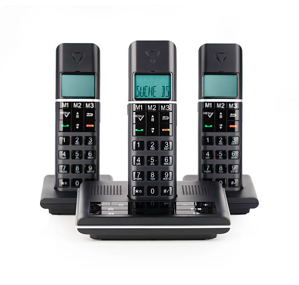 Three black cordless telephones on white isolated