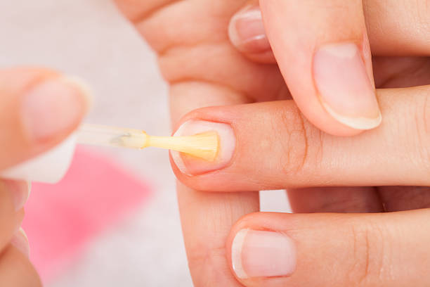 istock Manicurist Applying Nail Varnish 526310503