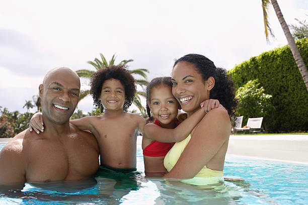istock Happy Parents With Children In Swimming Pool 526310873