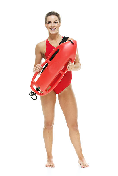 istock Female lifeguard with life buoy 526311193