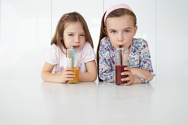 istock Girls With Orange And Chocolate Drinks At Table 526311923