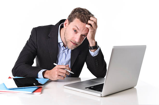 istock businessman working in stress at office desk computer suffering headache 526313459