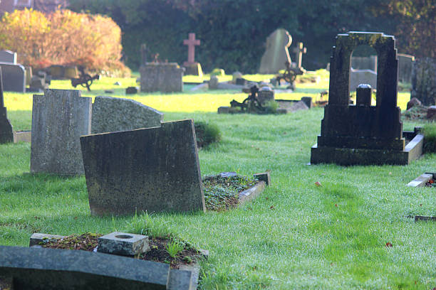 istock Neglected RIP gravestones / crosses, church graveyard cemetery image, leaning / falling-over 526313543