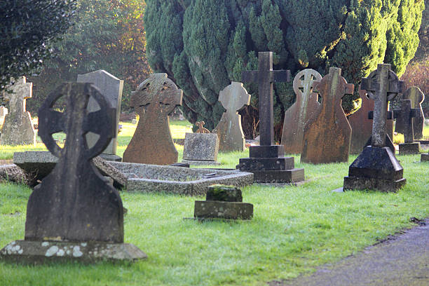 istock Neglected RIP gravestones / crosses, church graveyard cemetery image, leaning / falling-over 526313547