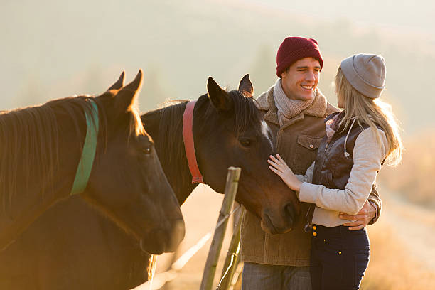 istock young couple petting a horse in a paddock 526321127