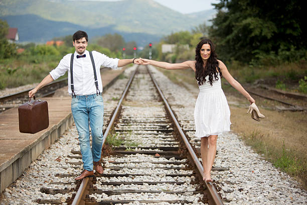 istock Bride and Groom on Railroad Track 526321335