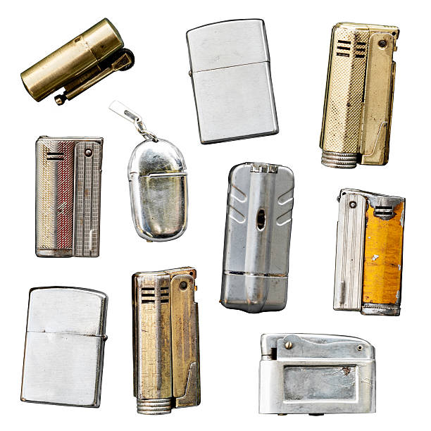 Collection of many different vintage cigarette lighters isolated on white.