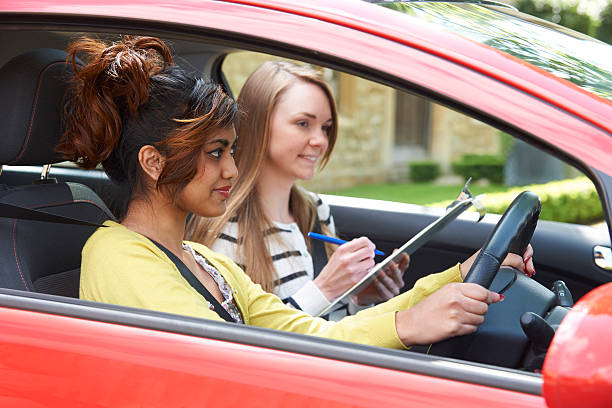 istock Young Woman Having Driving Lesson With Female Instructor 526324903