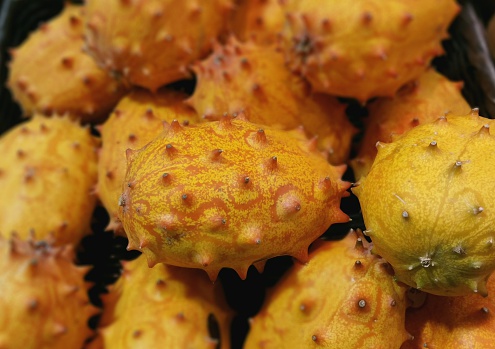 Horned Melon  (Cucumis metuliferus) at a produce stand.   Also known as Blowfish Fruit, kiwano, African horned cucumber or melon, jelly melon, hedged gourd and melano.