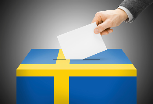 Voting concept - Ballot box painted into national flag colors - Sweden