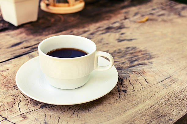 istock Cup of coffee on wooden table 526353087