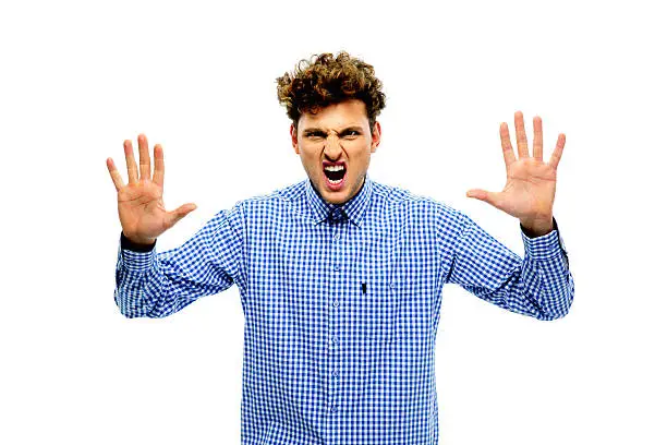 Portrait of angry young man with raising hands up