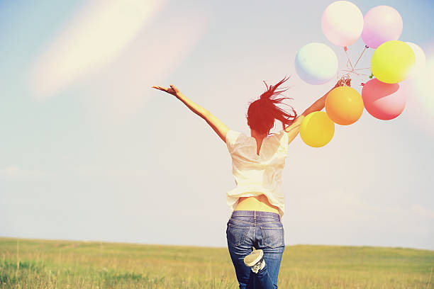 istock young asian woman  with colored balloons 526355321