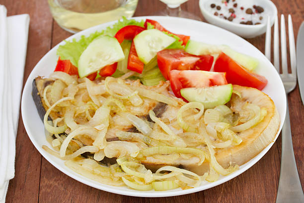 istock fish with onion and fresh salad 526357361