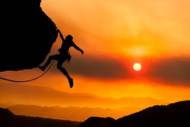 Climber grips the edge. stock photo