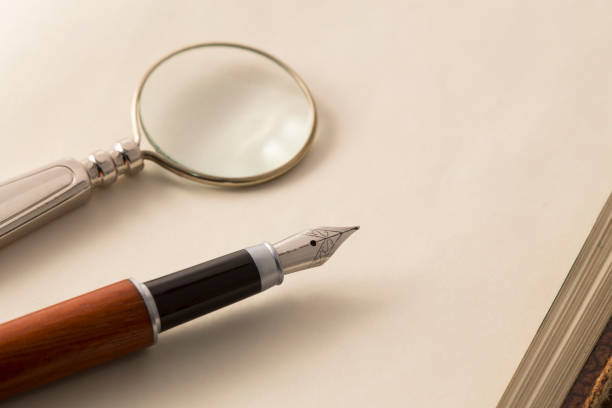 istock Fountain pen and the magnifying glass 526369577