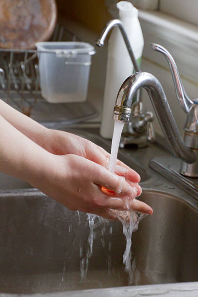 istock Hand Washing in the Kitchen Sink 526369957