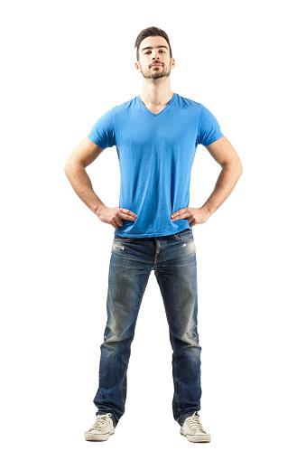 Confident proud young male in akimbo pose. Full body length isolated over white background.