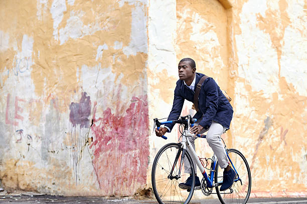 istock riding bike black man 526370425