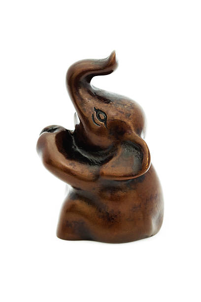 istock wooden elephant statue from Thailand isolated on white 526371419
