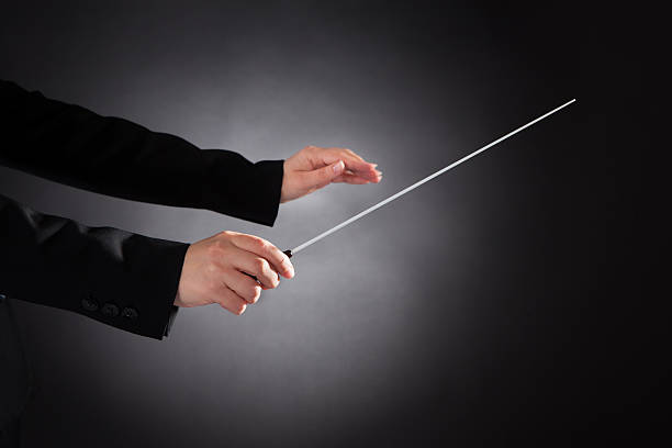 istock Female Orchestra Conductor With Baton 526374549