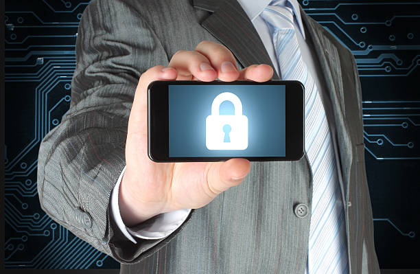 istock Businessman holds smart phone with closed lock 526375475