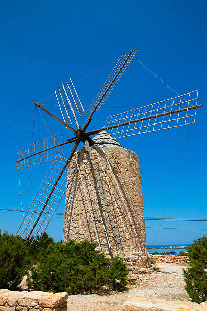 istock Formentera Windmill wind mill vintage masonry and wood 526375869