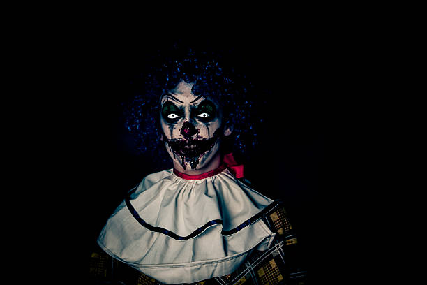 istock Crazy ugly grunge evil clown on Halloween making people scared 526388637