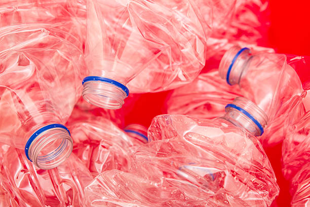 Squeezed bottles of mineral water with a red background