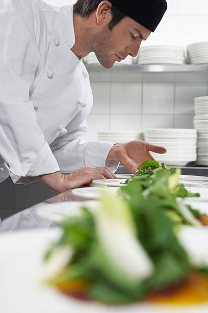 istock Male Chef Preparing Salad In Kitchen 526391605