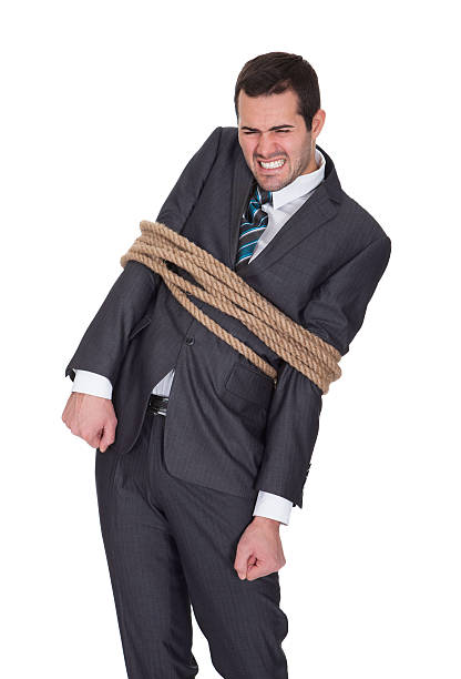 istock Businessman tied up in rope 526391825
