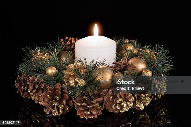 Christmas Decoration With A White Candle And Pine Apples Stock Photo - Download Image Now