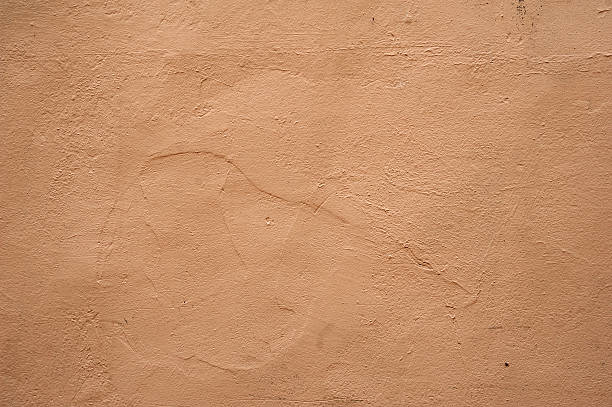 istock Texture of old wall covered with brown stucco 526392499