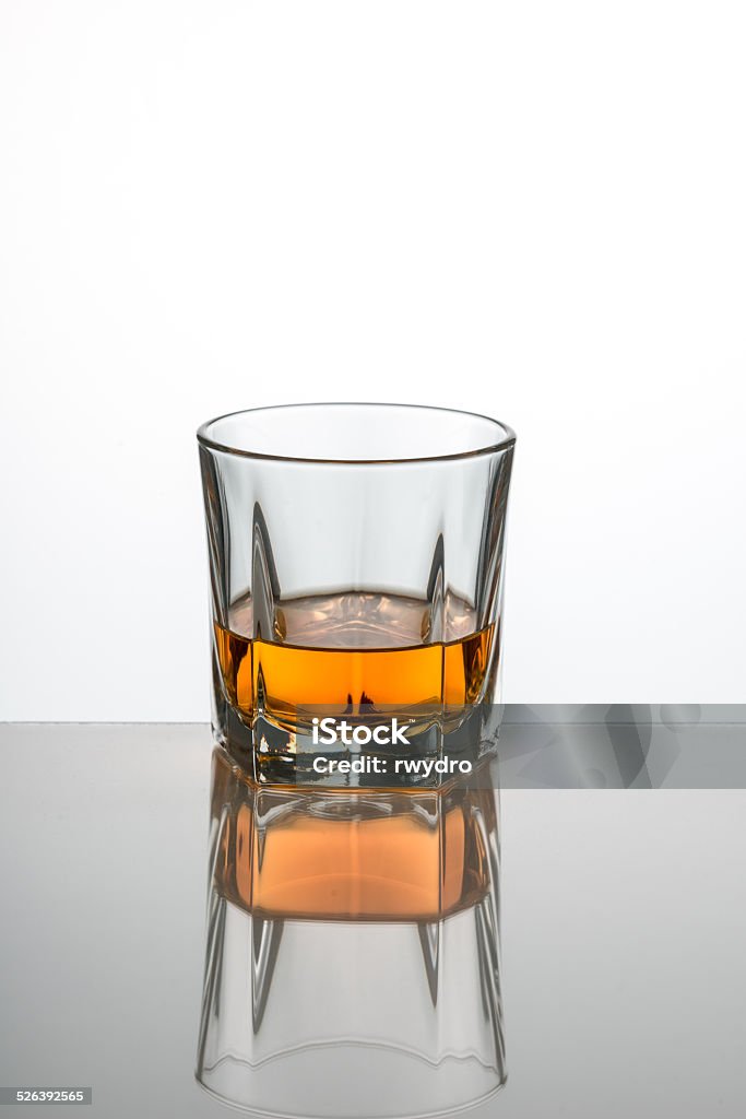 Whiskey Glass Whiskey glass with whisky photographed on a white background with reflection Alcohol - Drink Stock Photo