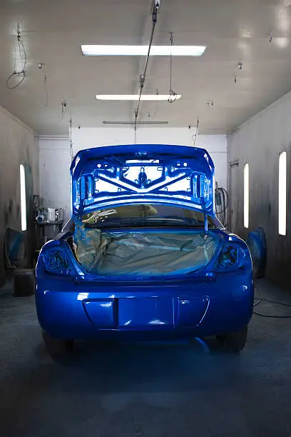 Rear of a newly blue repainted car in garage