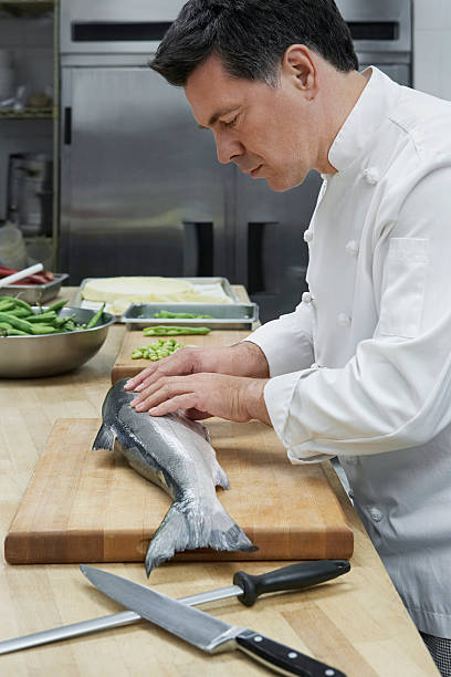 istock Male Chef Preparing Salmon In Kitchen 526395553