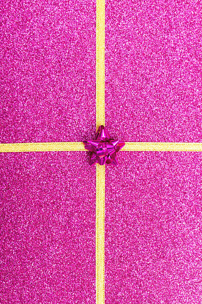 istock gold gift ribbon bow on purple shiny background 526395575