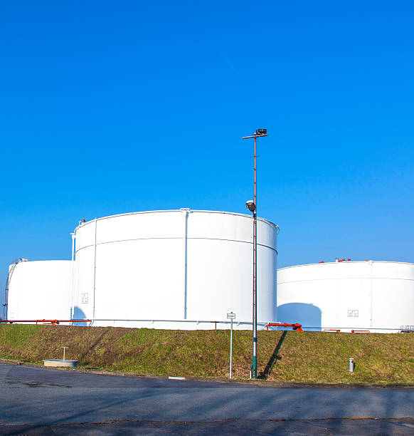 istock white tank in tank farm with blue sky 526421337